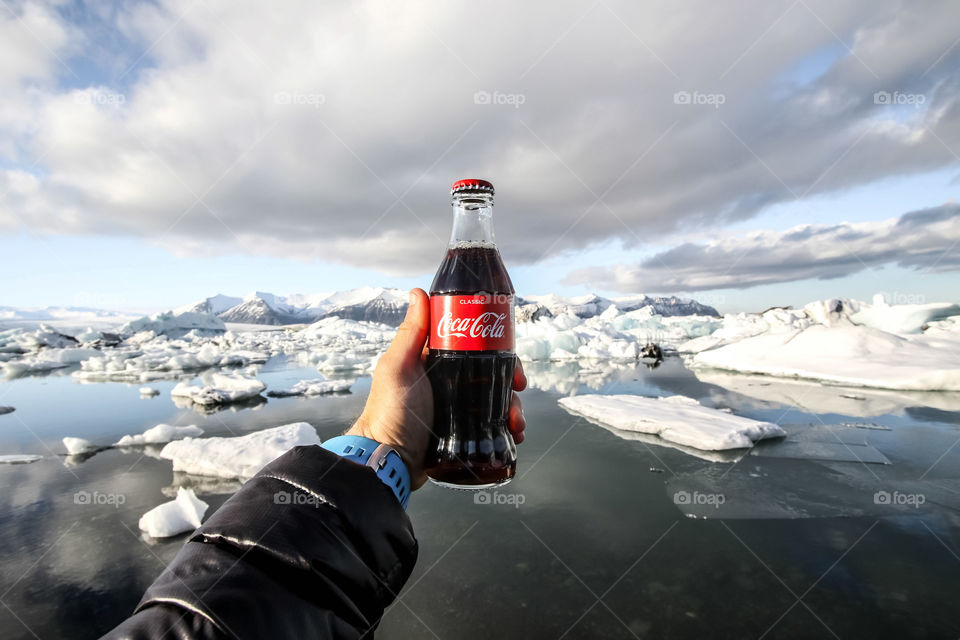 Person Holding Coca Cola Bottle