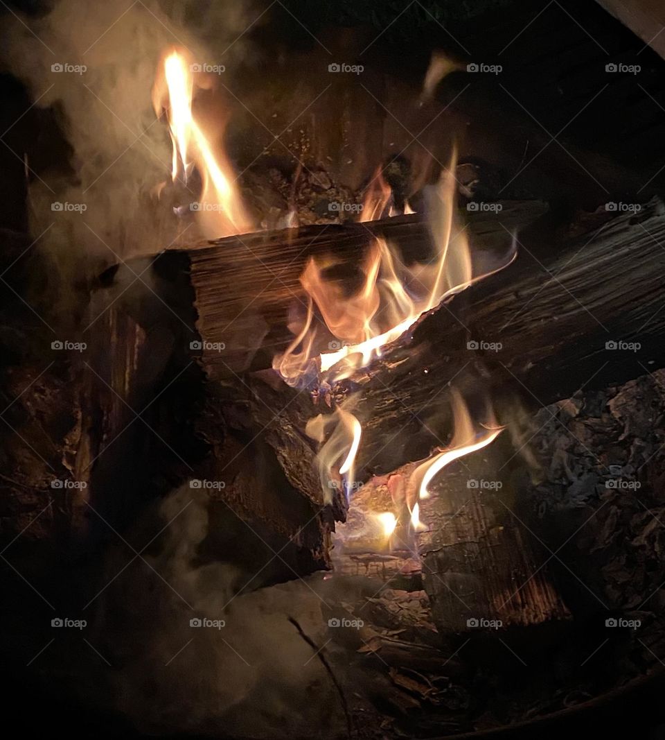 Camp fire at lodge with wet wood