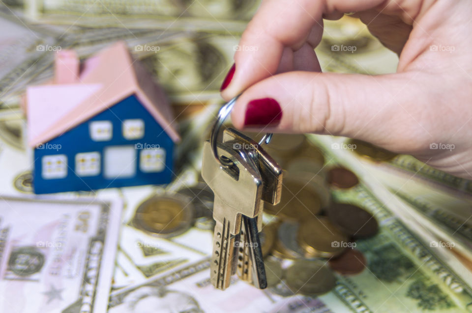 Keys, money, house in hands