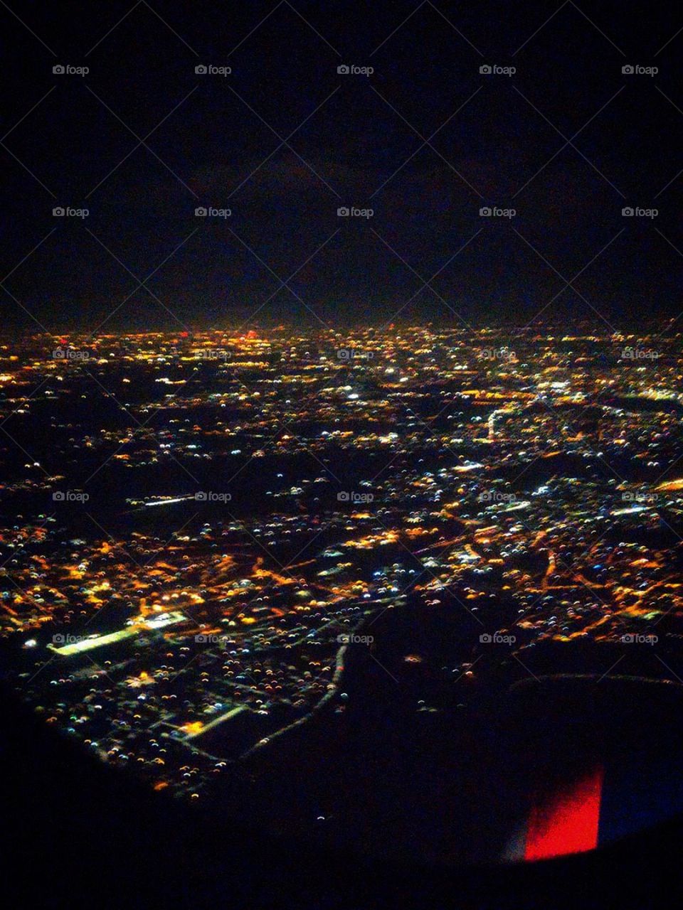 Big city lights from the airplane window. Milan. Italy