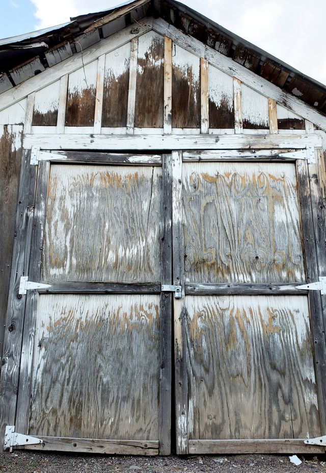 A weathered wooden door has lots of character and makes one wonder what secrets are contained behind the lock.