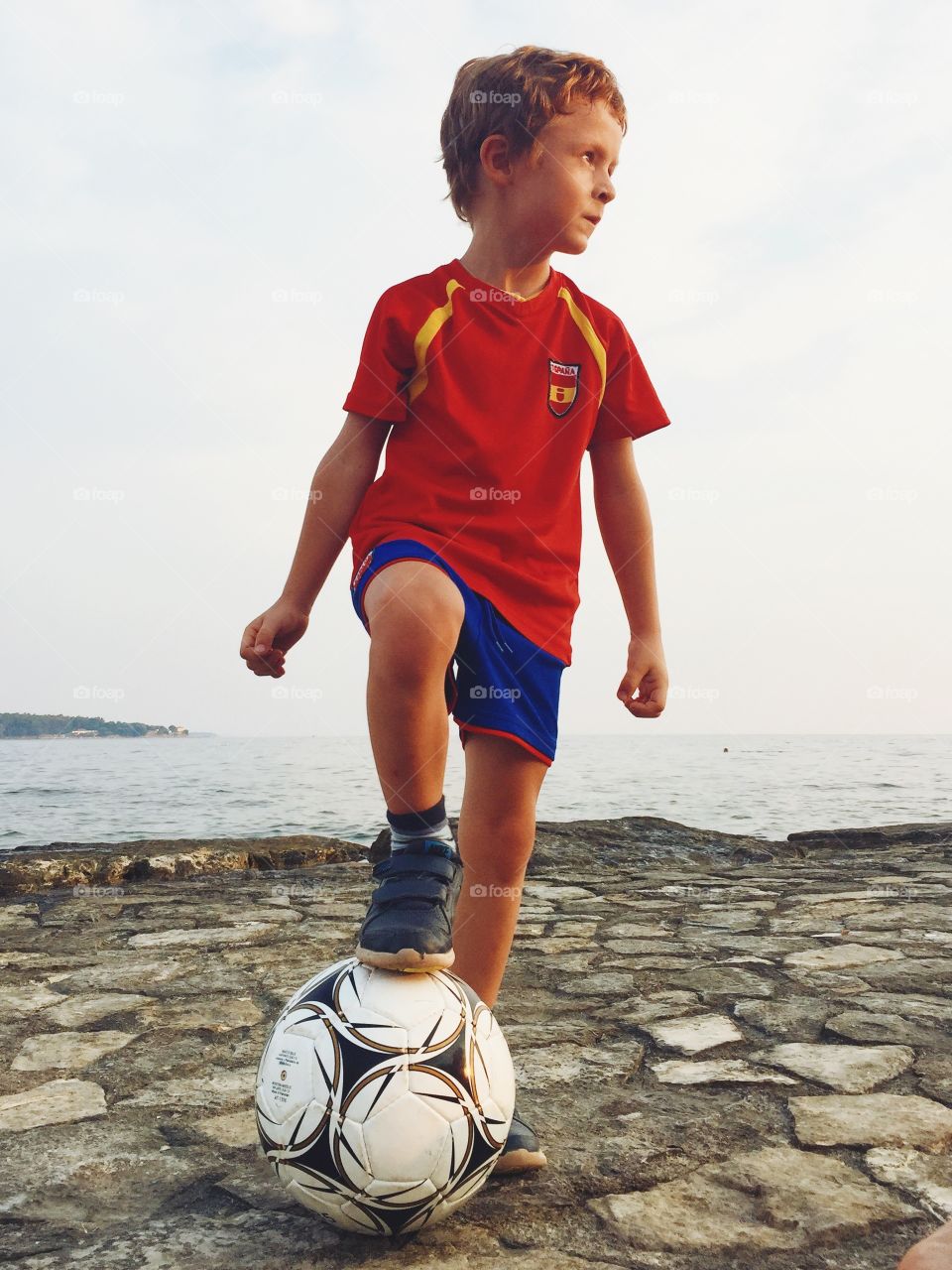 Doing it like Messi. . Summer fun photo of a kid playing soccer like Messi. 