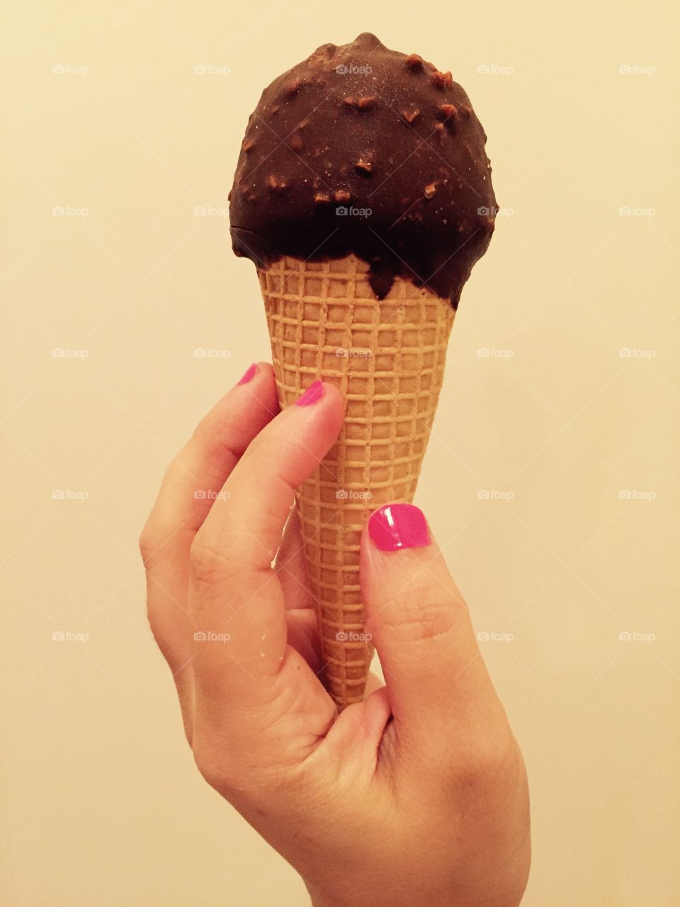 Hands holding Ice Cream. Ice cream candy dipped cone