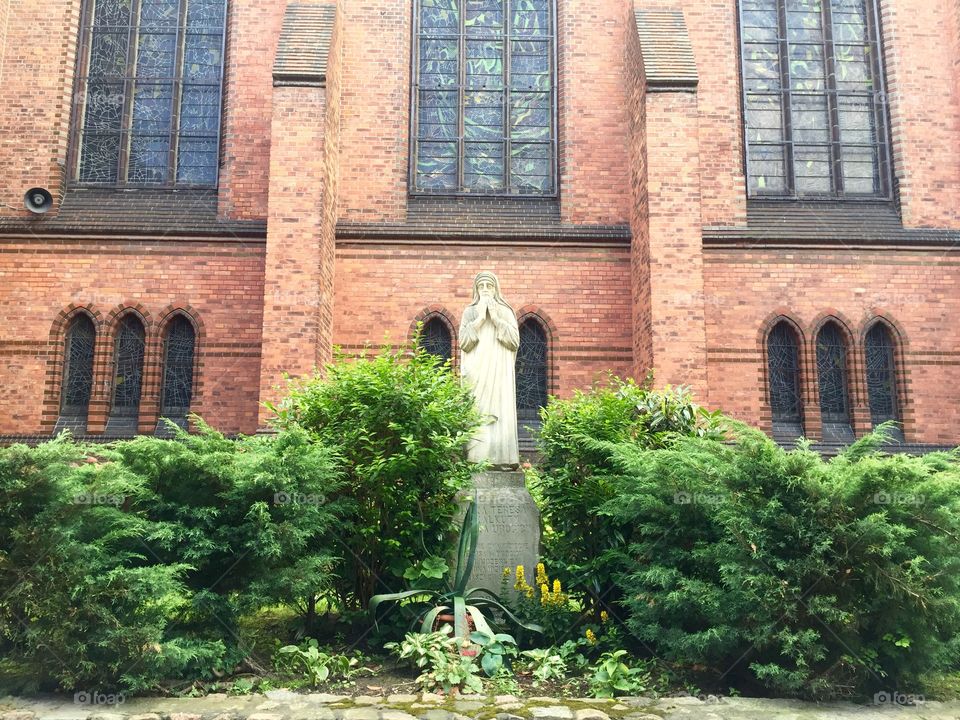 A statue of St. Maria in the courtyard of a Church