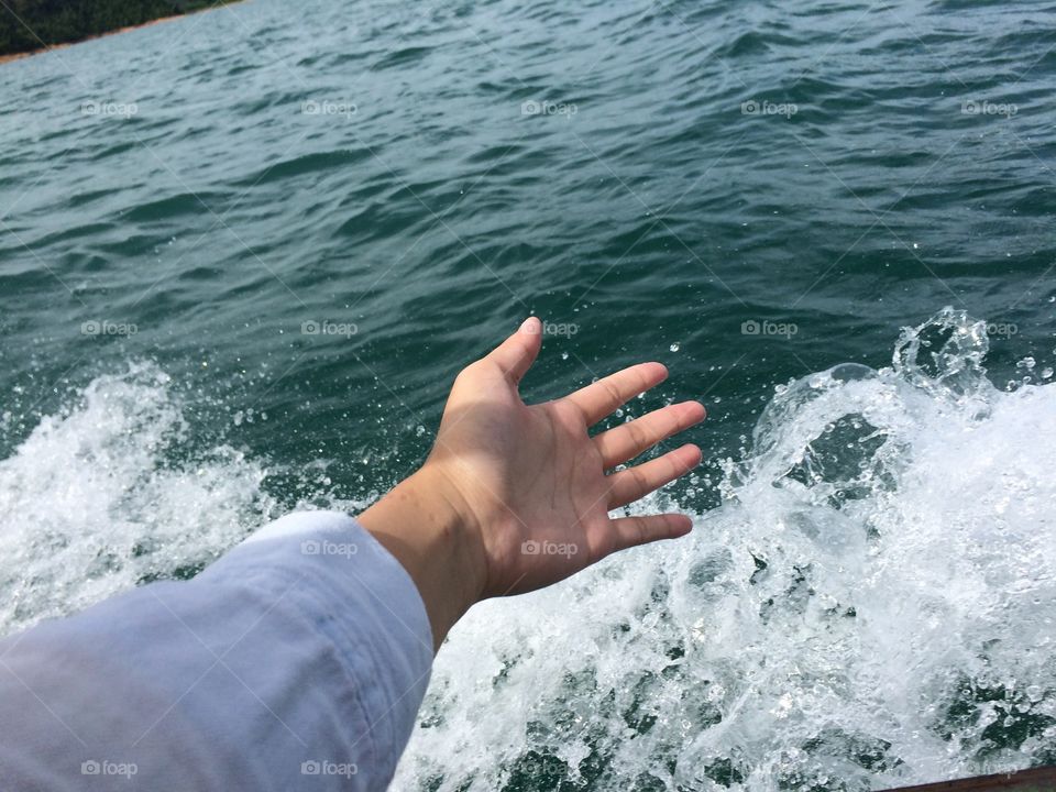 Female hand free with water wave foam - like freedom 