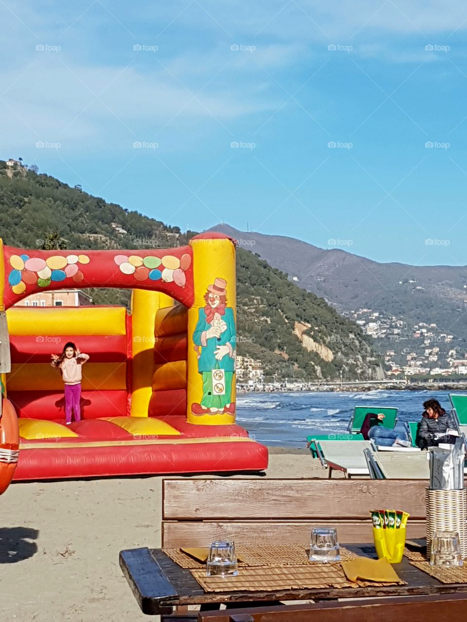 Fun on the beach in a sunny day in italian Riviera