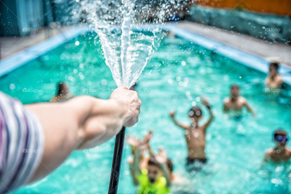 Close-up of person spraying water in pool