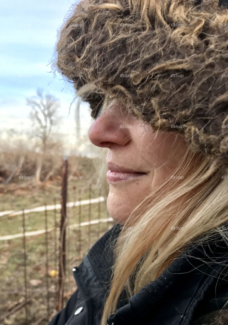 Winter stories, winter, stories, caring, fence, woman, cold, hair, blond, windy, windy, rust, frozen, brown, grass, eyes, ears, mammal, human, beautiful, profile, side view, day, daylight, overcast, gray, coat, hood, fur, gloves