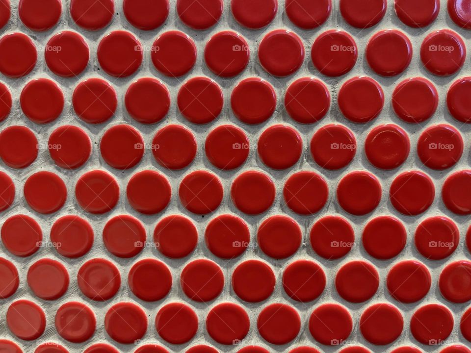 Red round tiles on the wall