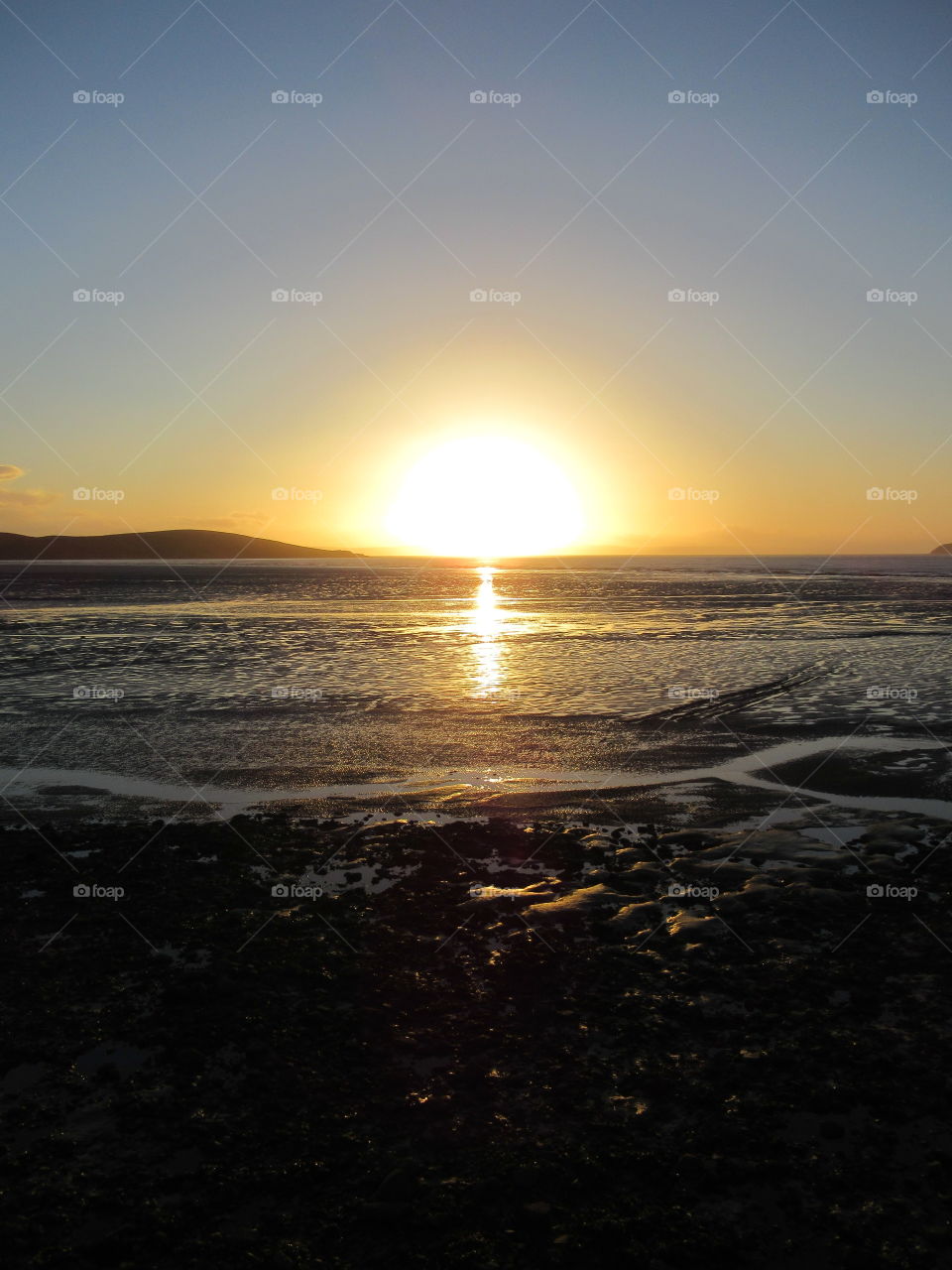 Sunset reflecting of the sea and sand