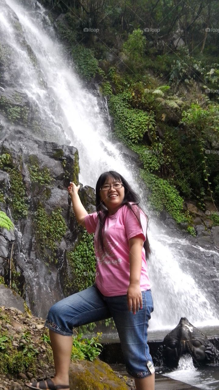 girl is enjoying the waterfall