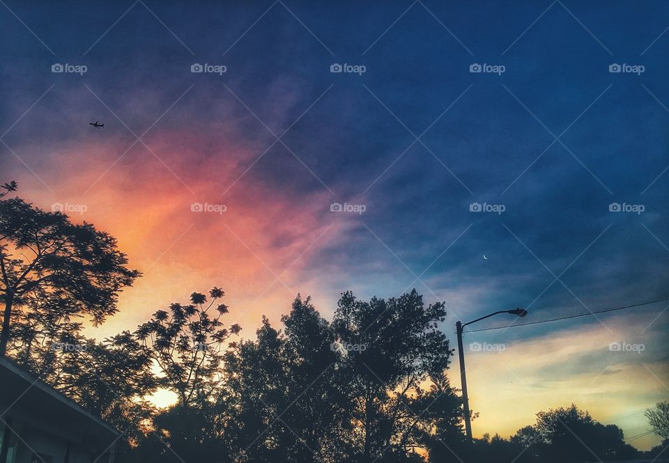 Sun rise getting ready to relieve the moon of its duties. 