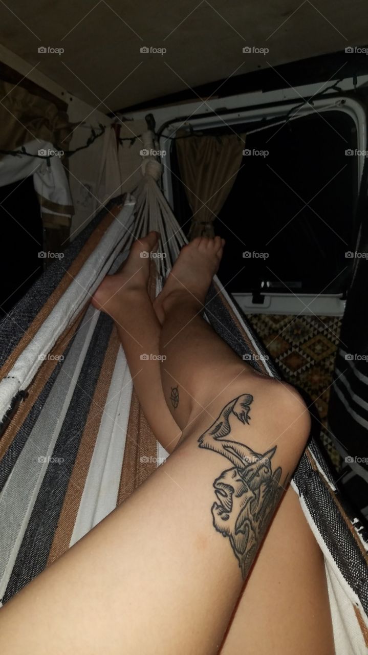 Girl laying in a hammock at night