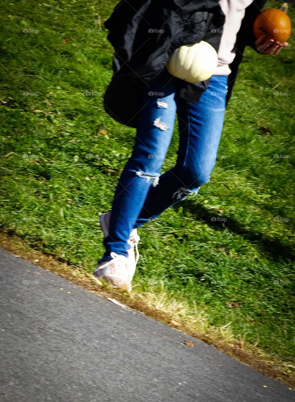 A person carrying a pumpkins 