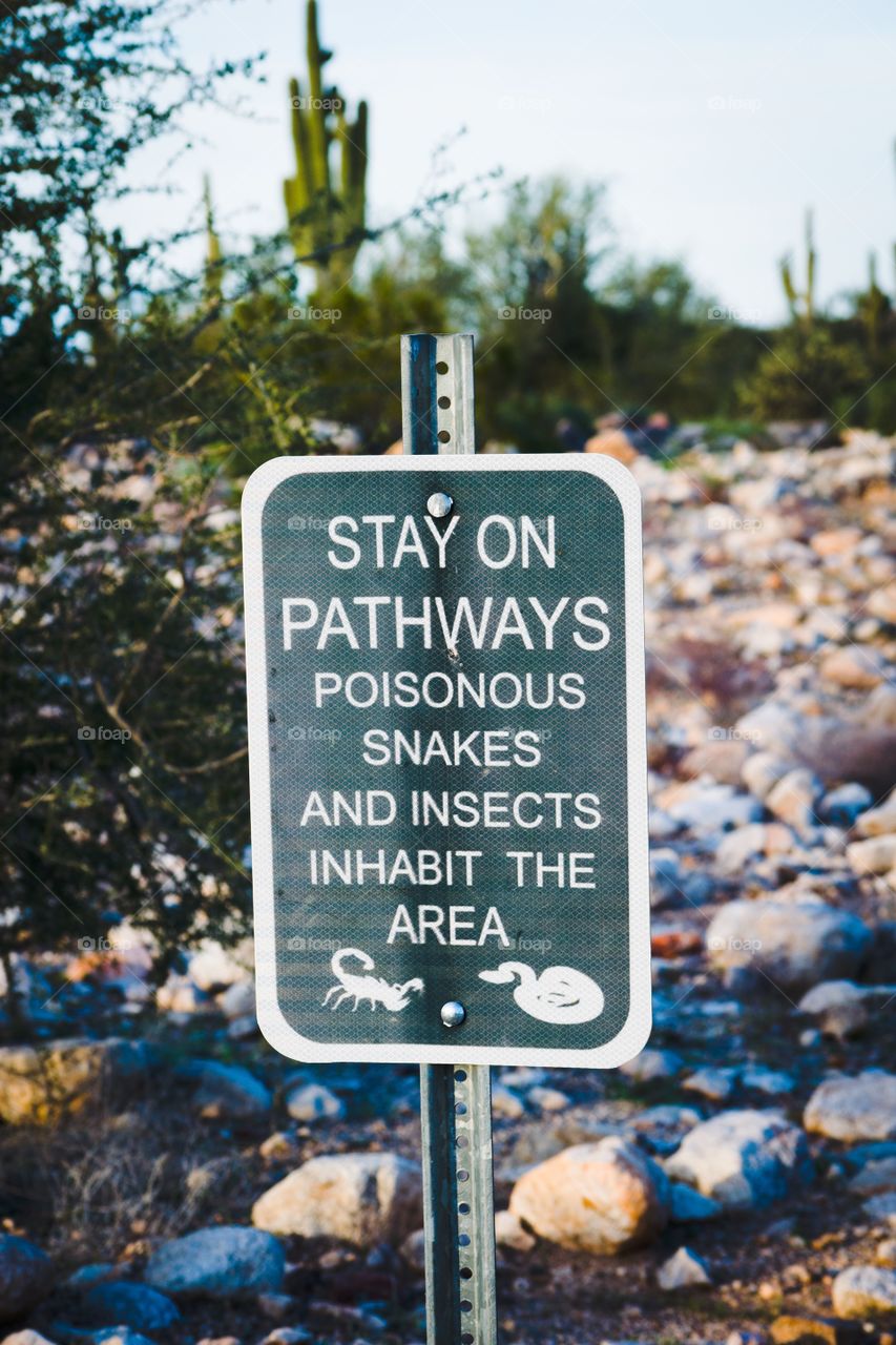 Sign warning of poisonous snakes and insects