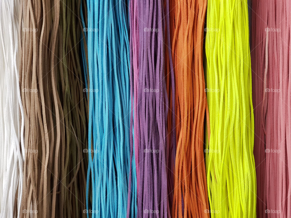 Colored leather straps. Multicolored ropes background. arts and crafts concept