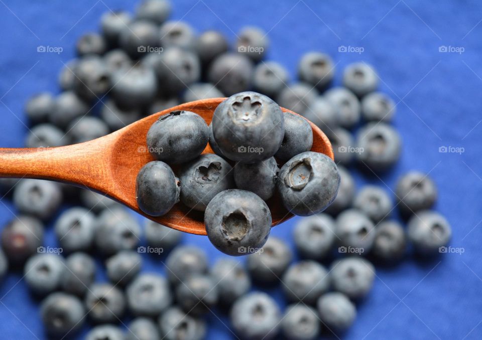 blueberries in wooden spoon taste summer food