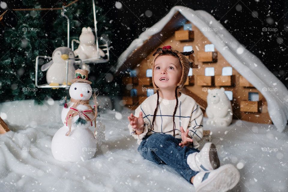 Happy baby playing with snow