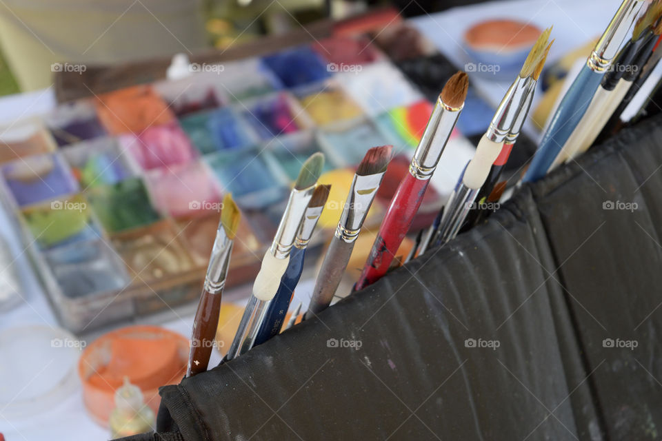 A set of artist's paint brushes and paints 