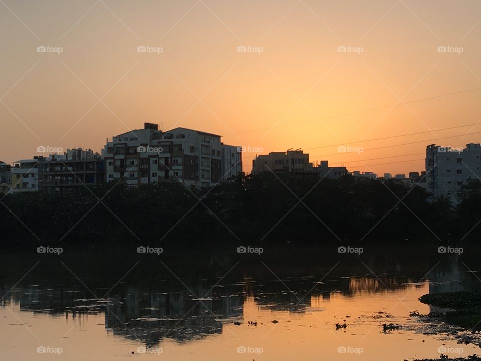 Beautiful sunset with mirror image of building blocks