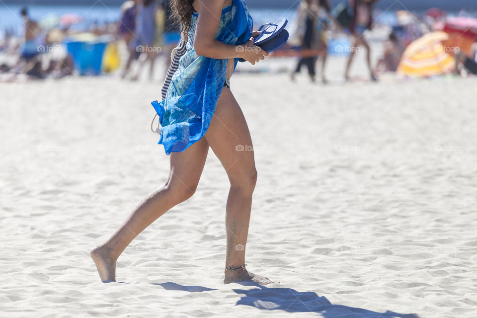 Woman at the beach, summer time, no head in the frame