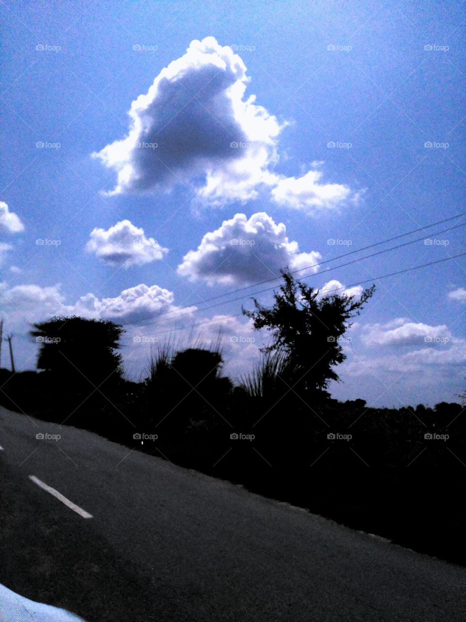Empty road against blue sky