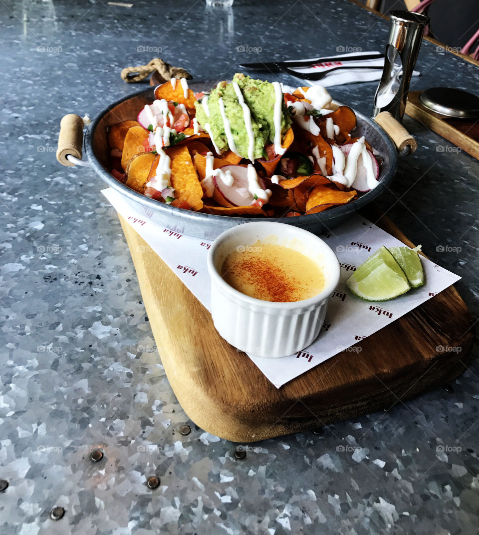 Kind of Mexican food with crispy fried potatos and cream sauce on the side. Pieces of lime make taste more interesting. Oh dear, I'm hungry again.