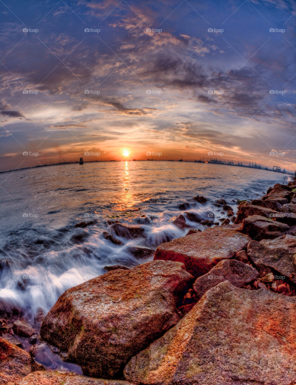 singapore sunset clouds sea by paulcowell