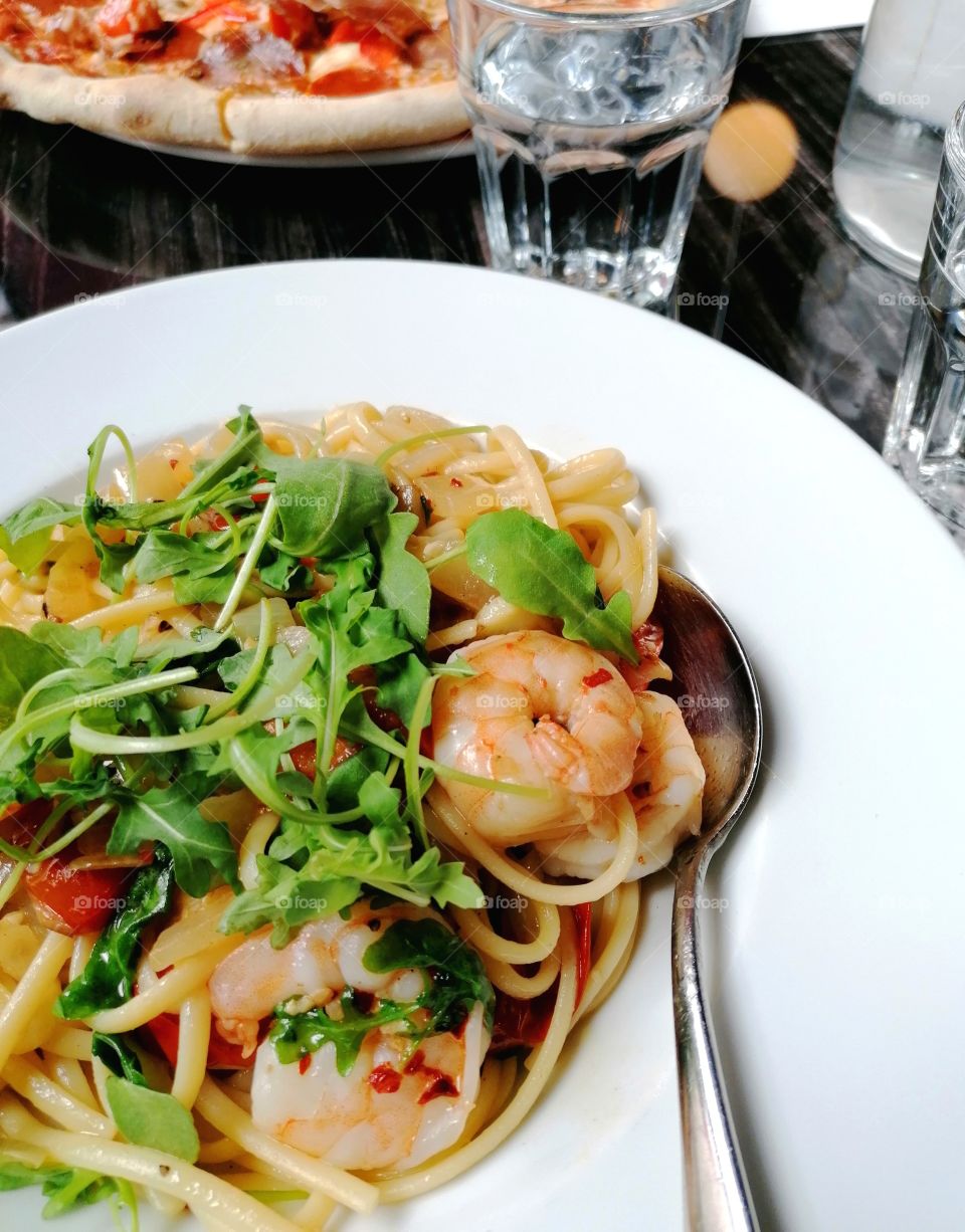 Eating at an Italian restaurant. Pasta with prawn tails in chili-lobster sauce. So good!