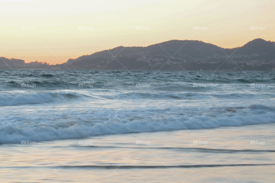 ocean waves at the sunset