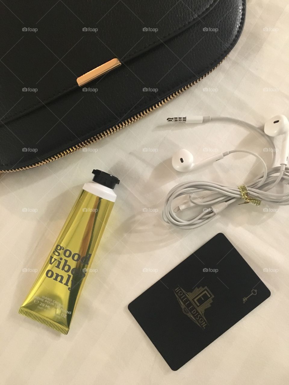 Travel essentials for your crossbody bag while urban exploring. Headphones, room key, and good vibes are inside. 