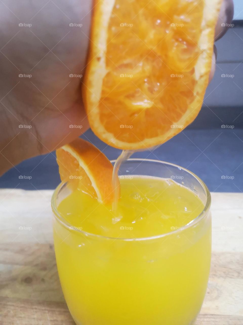 A glass of freshly squeezed orange juice with ice cubes