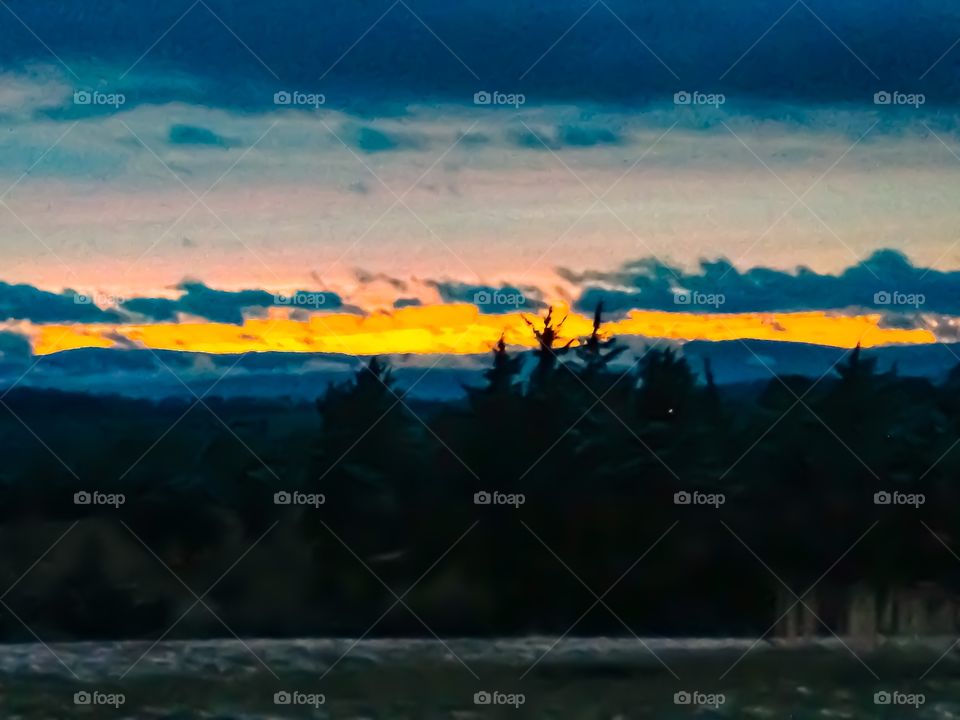 Magnificent golden sunset over a picturesque mountainside and wonderful cumulus clouds 