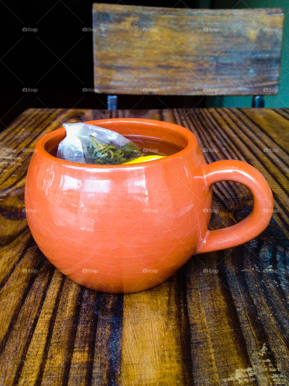 Green tea with lemon and ginger on natural wood table 