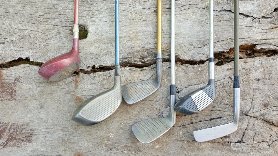 golf clubs on wood background