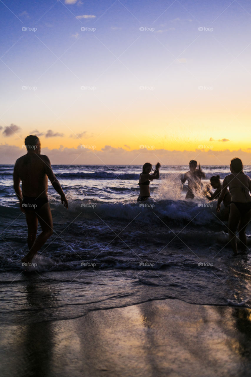 Playing in the waves in the sunset

