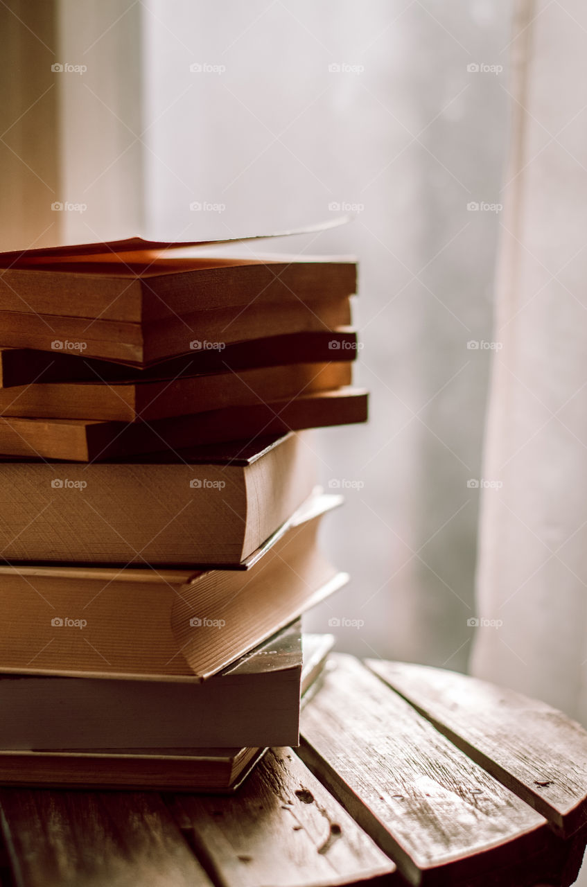Pile of books by the window