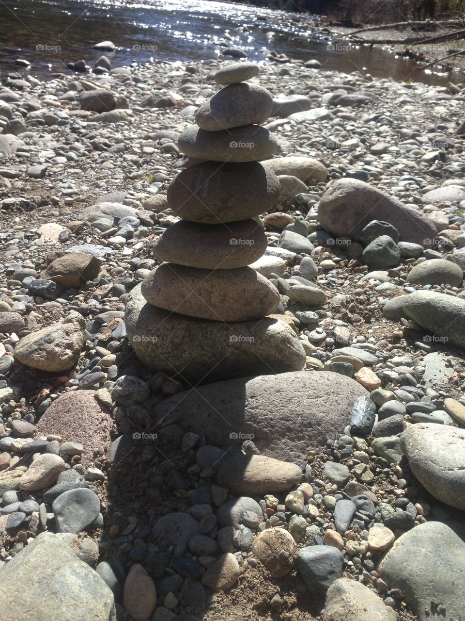 Rocks perfectly stacked by the river.