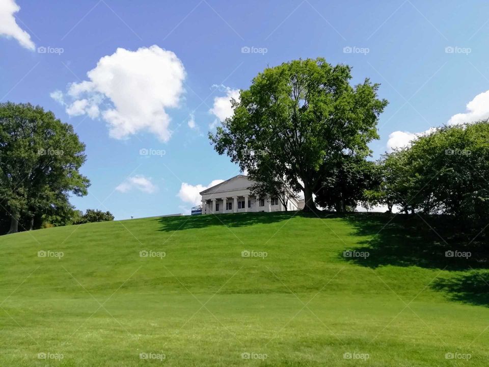 White house surrounded by trees and overlooking the green lawn