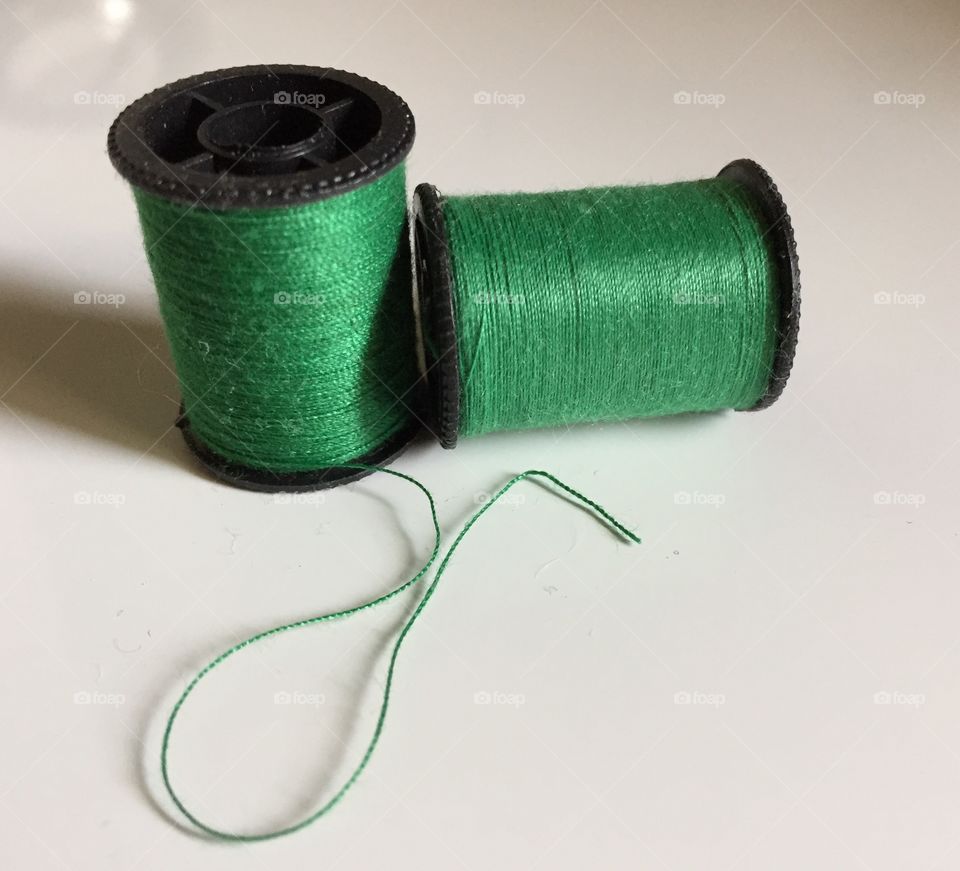 Green spools of thread