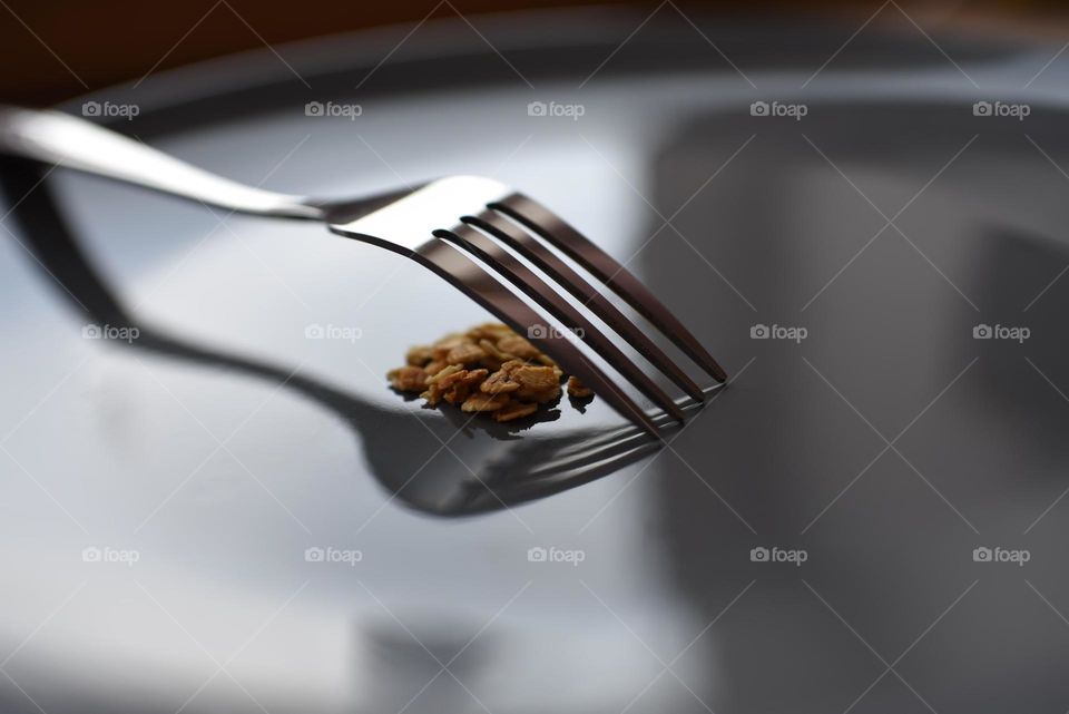 metal fork on a gray plate with oatmeal