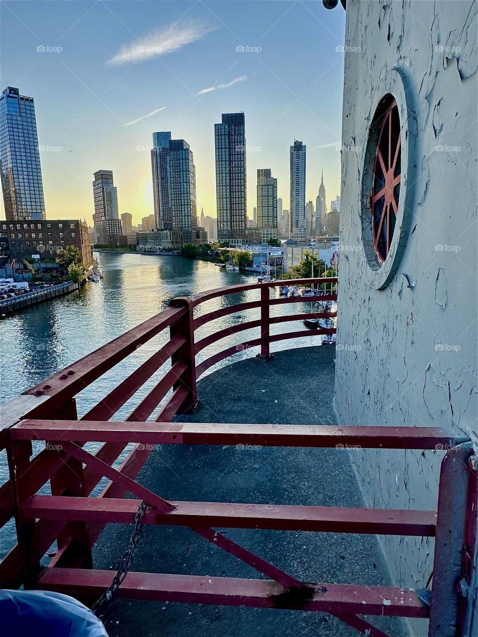 This is the central outpost of the “Pulaski Bridge” at “Newtown Creek” connecting “Greenpoint”, Bklyn to LIC, Queens. Across the “East River” we see “Manhattan” including the “Empire State Building”. 2024. Hypnotic Productions