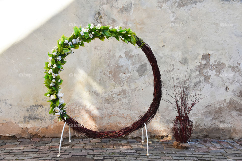 Wedding arch in the garden of medieval palace, round shaped 