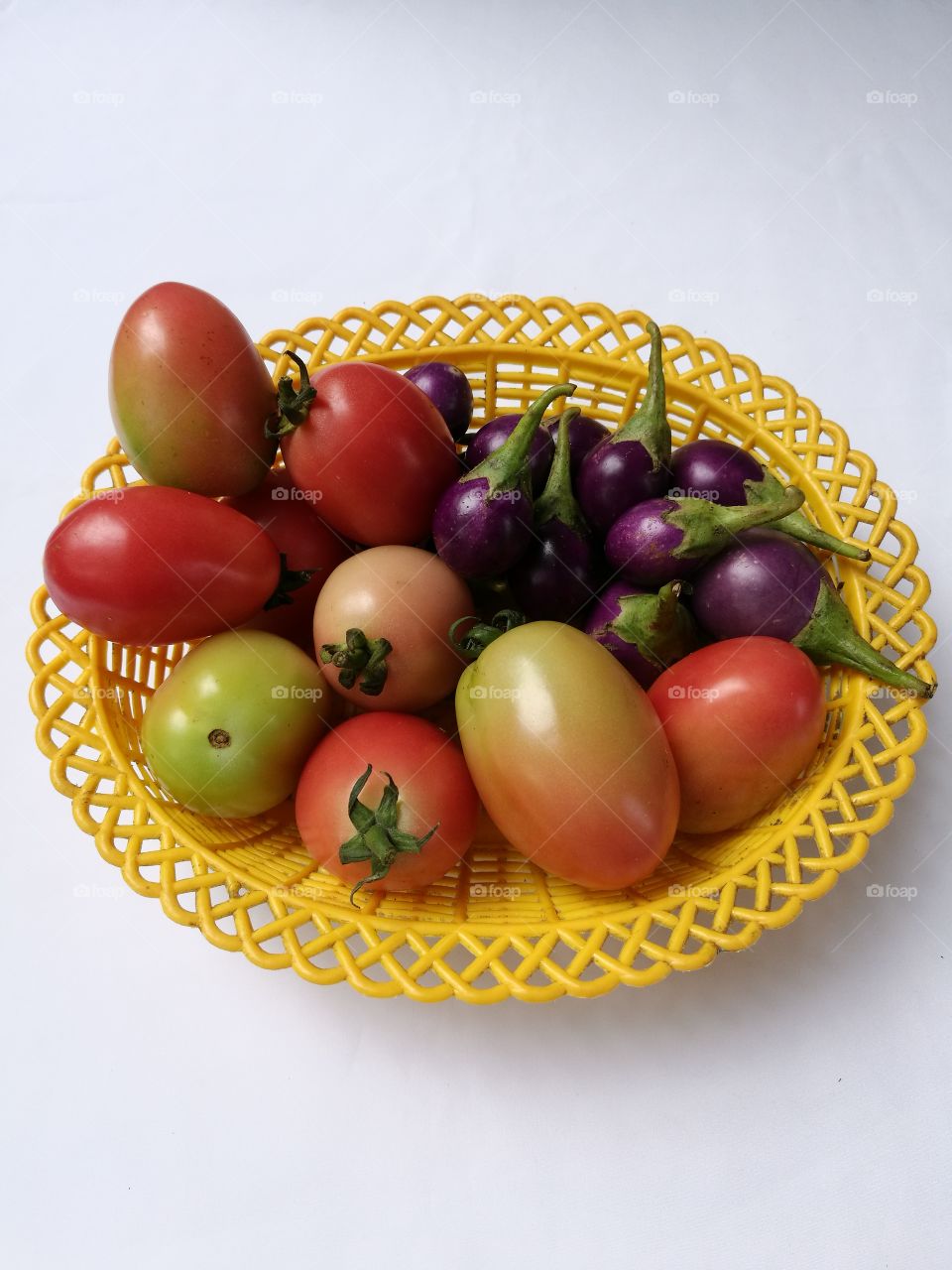 tomatoes and eggplants in basket