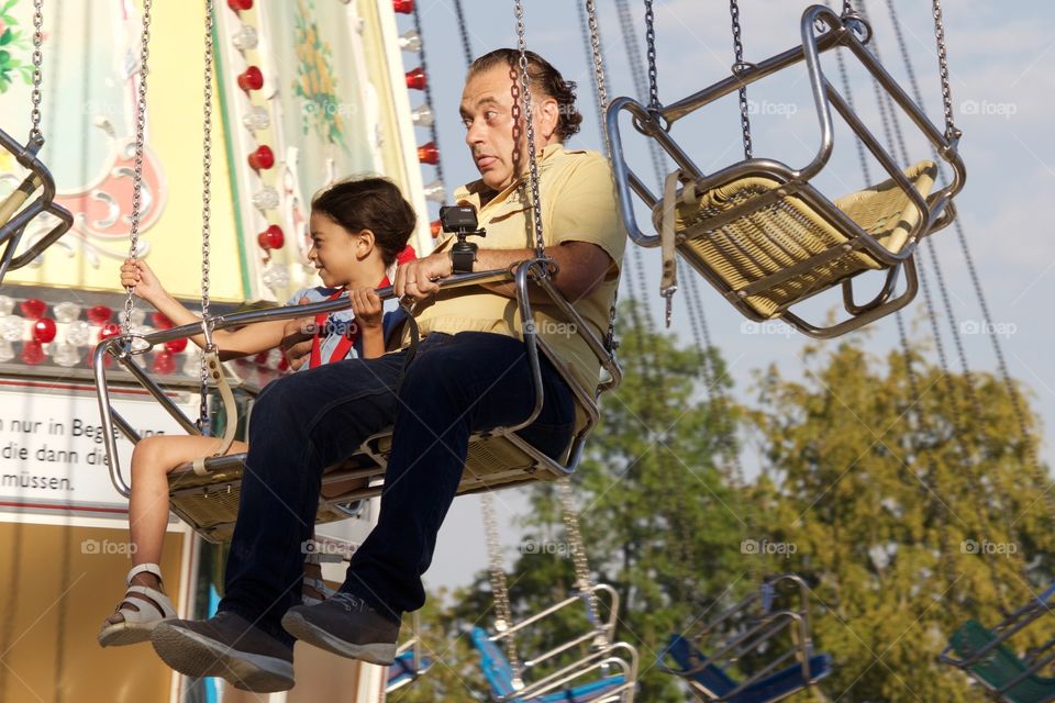 View of father and daughter on giant wheel