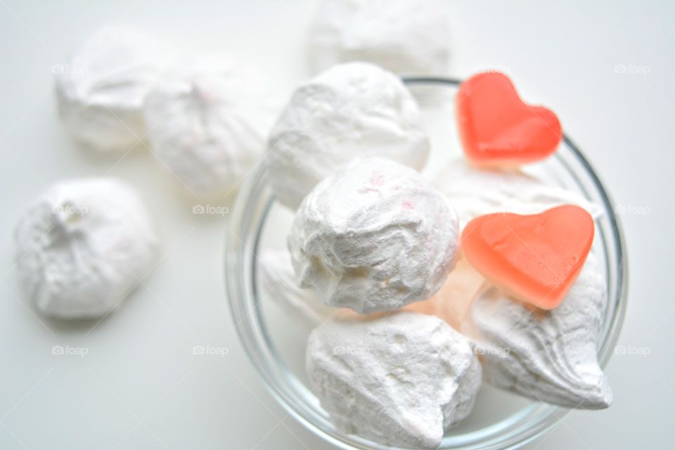 sugar meringues and candy hearts white background tasty food