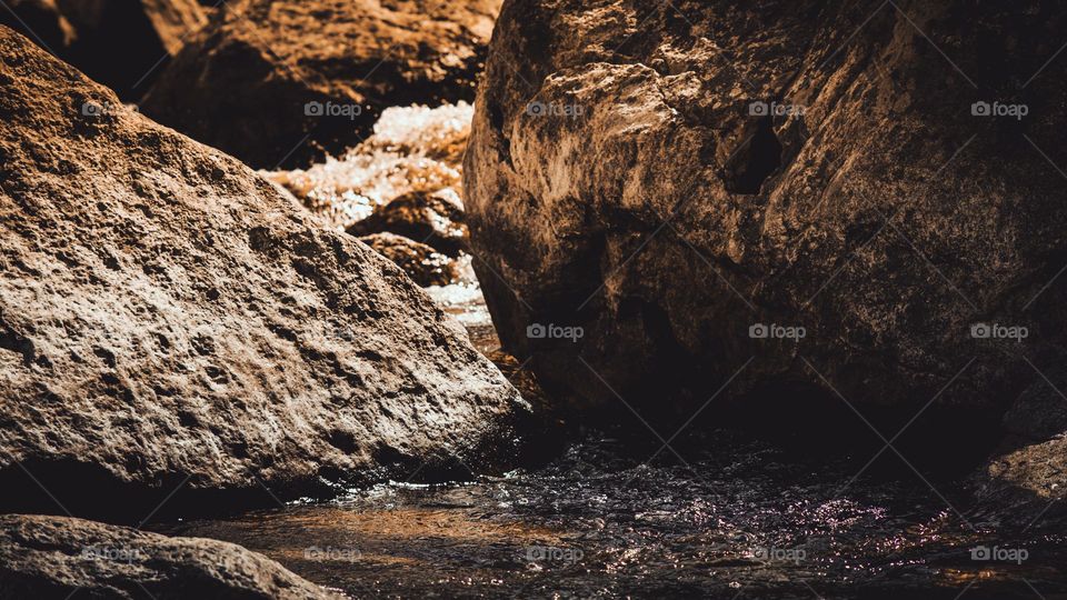 River leading down to emerald lake.