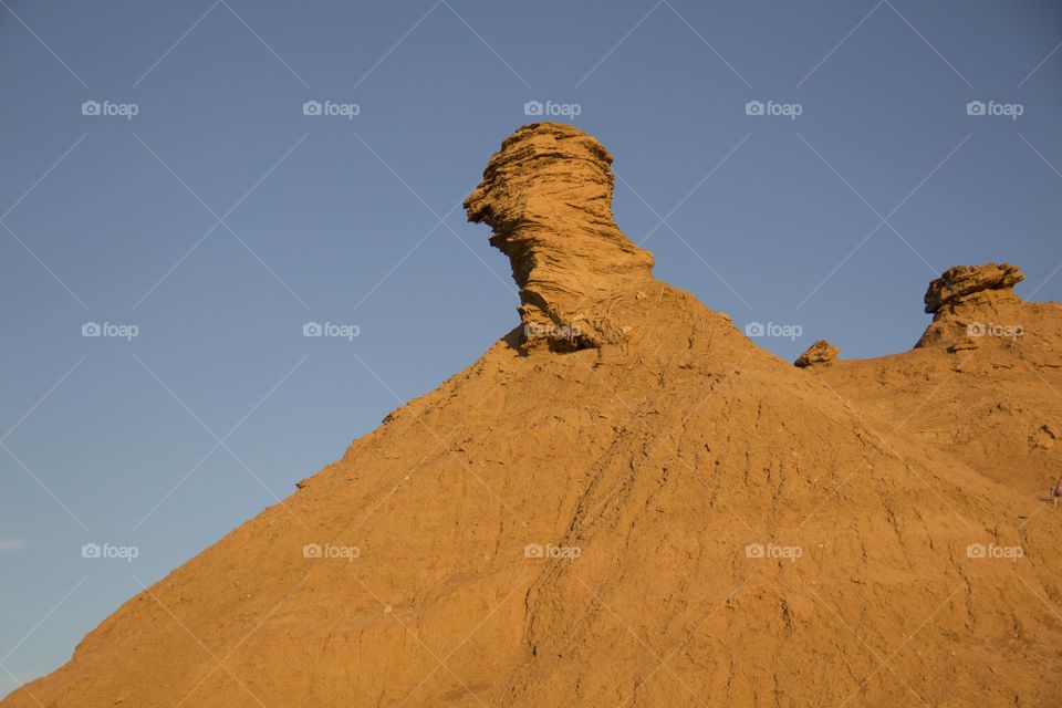 Mountain in the Sahara desert against the blue sky.