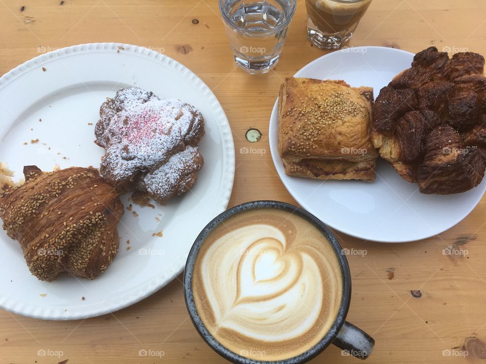Latte and pastries on a wooden table