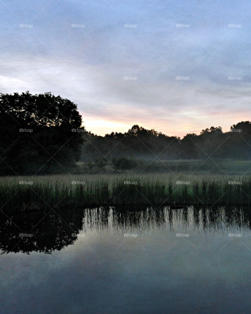 A peaceful evening on the lake at dusk.
